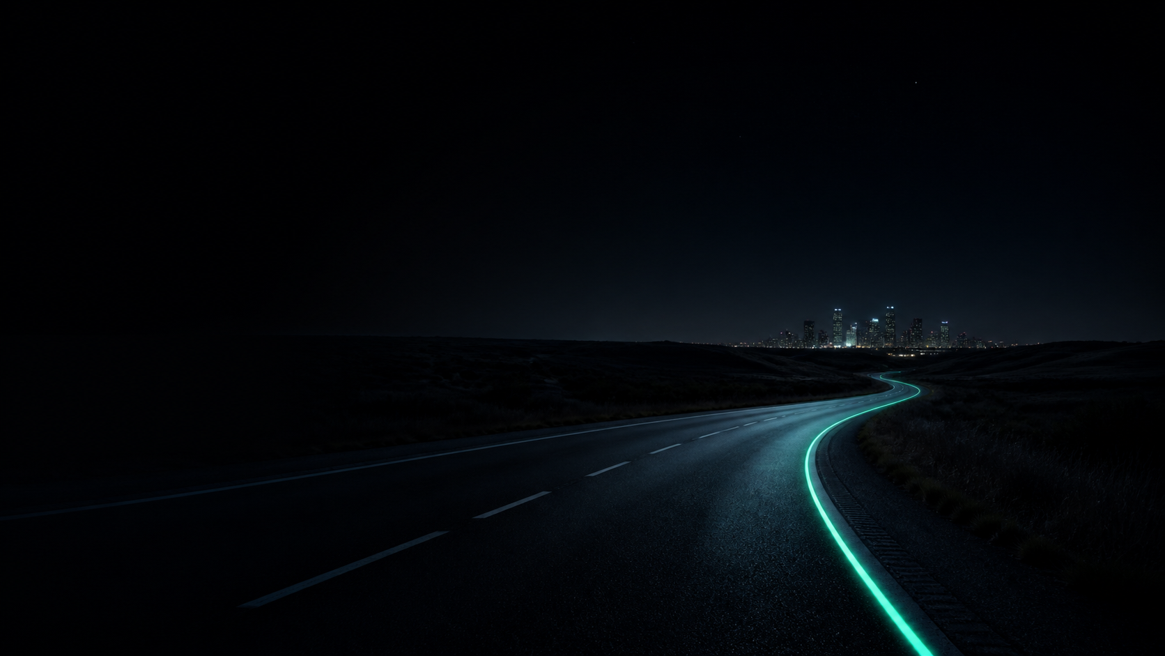 An open night road leading toward a distant city, marked by an emerald line